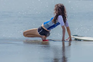 Candid girls surfing on the beach