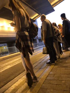 Cute Teen in Shorts on the Tram Stop