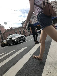Young Girl in Shorts And Sandals Crossing the Street Gallery