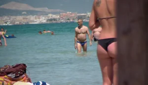 Amazing ass in semi-thong bikini on the beach with tanlines