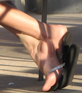 Lady in flop flops while eating showing her feet