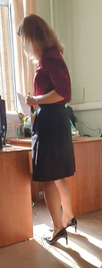 Hot teacher wearing stiletto heels and a skirt in classroom