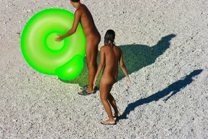 FKK Nudists playing in the water with floater