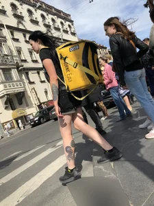 Amazing cute candid food delivery girl with lots of tattoos crossing the street