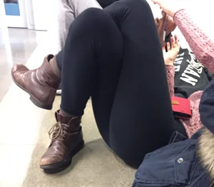 Girl in Leggings Lying on the Floor Carpet With Crossed Legs