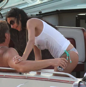 Bikini babe on a boat with a wet see through white shirt showing her tits