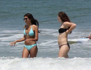 Brunette and redhead on the beach in bikinis looking sexy