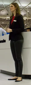 Pretty car saleswoman in tight shiny black pants with nice ass
