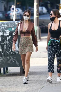 Emily Ratajkowski in mini skirt out for a walk with a friend in New York