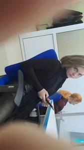 Studentgirl in a leather skirt stares intently