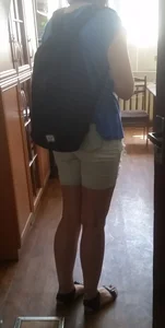 Hot ass and legs of a college teen girl entering classroom wearing shorts and a backpack closeup creepshots