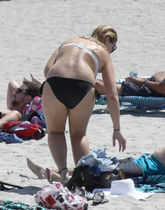 Big boobed thick blonde on the beach in a bikini