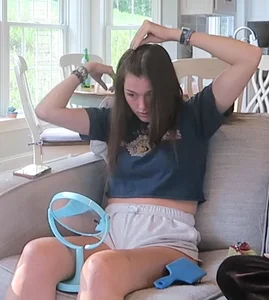 Cute Girl in Shorts Making Her Hair