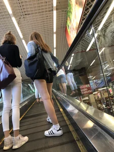 Hot Girls on the Mall Travelator in Mini Shorts and Her Friend in White Pants - Skinny Hot Legs Creepshots
