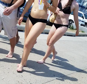 Cute brunette looking sexy in black bikini with friends