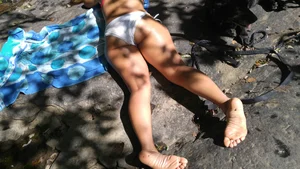 Sexy bikini ass laying out on the rocks up close