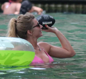 Blonde bikini girl at the pool in pink bikini top with amazing tits