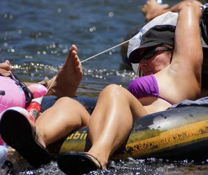 Sexy party girls in bikinis on a lake