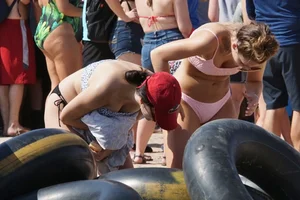 Girls in bikinis getting ready for tubing