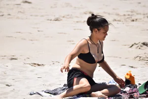 Beach girl can't keep her tits in her bikini