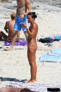 Smoking milf at a nude beach with a hairy pussy