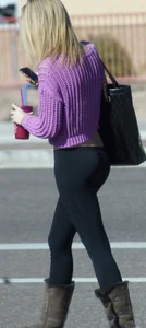Beautiful skinny blonde in tight leggings and purple crop top showing sexy stomach
