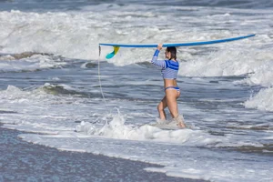 Candid girls surfing on the beach