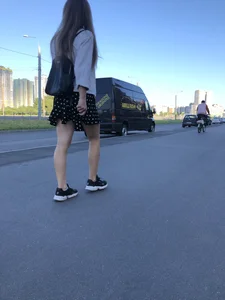 Extremely Cute Girl in a Skirt With a Backpack Passing By on the Street Gallery