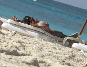 Lady with big tits wearing pink thong on the beach