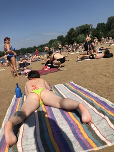 Candid girl lying on the beach with widely spread legs creepshot