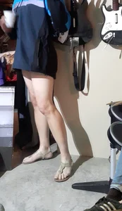 Sexy girl with great legs in coat and short skirt at Halloween party