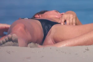 Topless beach lady in little thong shows tits, pussy slip and asshole