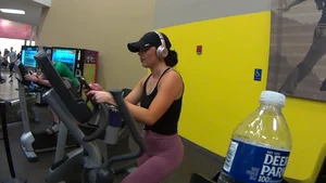 Smoking hot brunette working out at the gym in tight leggings