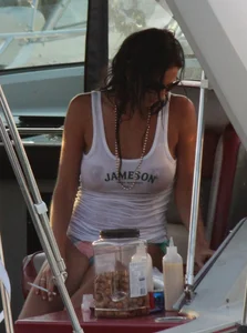 Bikini babe on a boat with a wet see through white shirt showing her tits