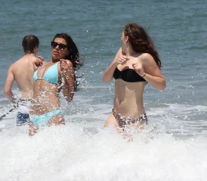 Brunette and redhead on the beach in bikinis looking sexy