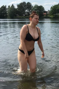 Big boobed babe at the lake in a black thong with blonde friend