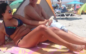 Thick brunette beach babe booty in a little black bikini