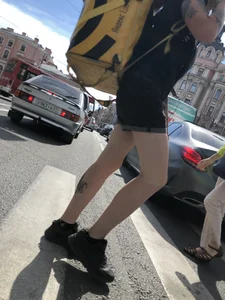 Amazing cute candid food delivery girl with lots of tattoos crossing the street