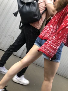 Very hot candid girl in denim shorts walking down the train platform