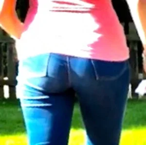 Girl wearing tight blue jeans in the backyard creepshots