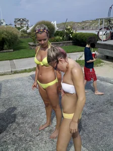 Two sexy babes in yellow bikinis at an ice cream truck