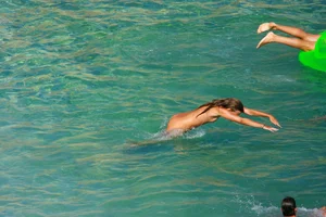 FKK Nudists playing in the water with floater