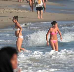 Two sexy friends out on the beach in bikinis