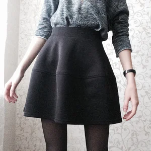 Cute Skinny Girl in a Skirt and Black Pantyhose Sitting on the Floor Selfies