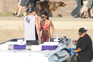 Brunette on a boat in red thong bikini with a tight little ass