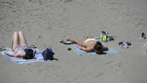 Sexy beach girl laying out in white bikini with nice body