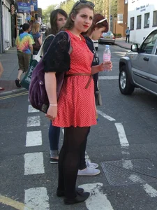 Girl in a pink skirt and stockings accidentally showing some cheek