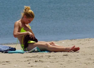 Sexy ass blonde milf on the beach in a thong with cameltoe and bending over