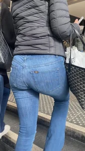 Nice big ass in tight blue jeans walking up stairs and standing in front of me