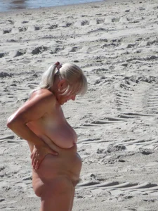 Mature blonde lady on a nude beach with big boobs